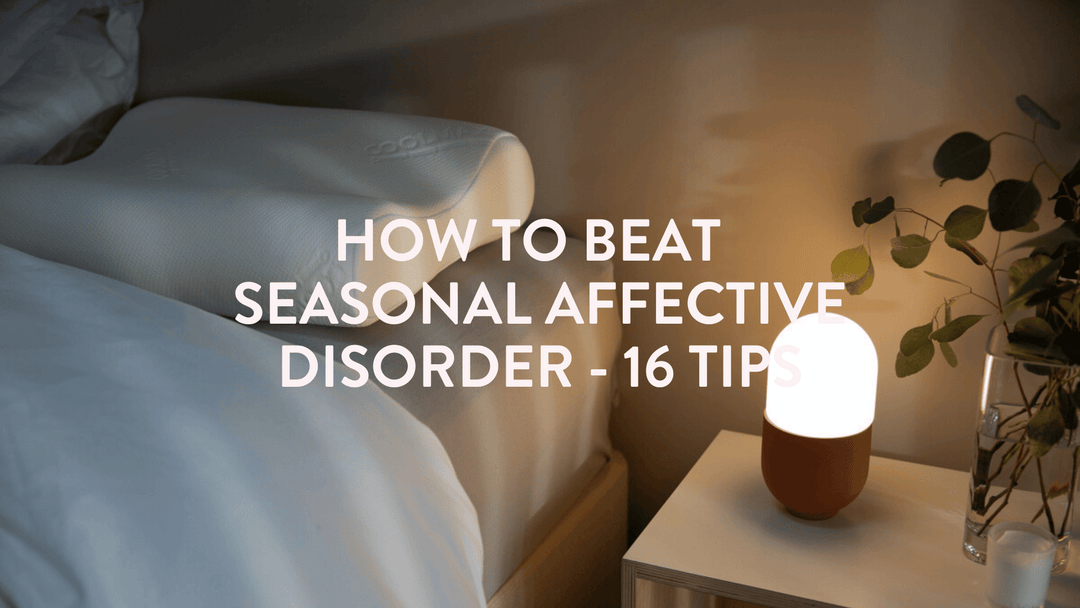 a quiet scene of a bed, pillow and seasonal affective disorder SAD lamp on the bedside table 