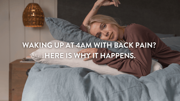 Person lying on a stack of Putnams pillows wide awake at night on a double bed