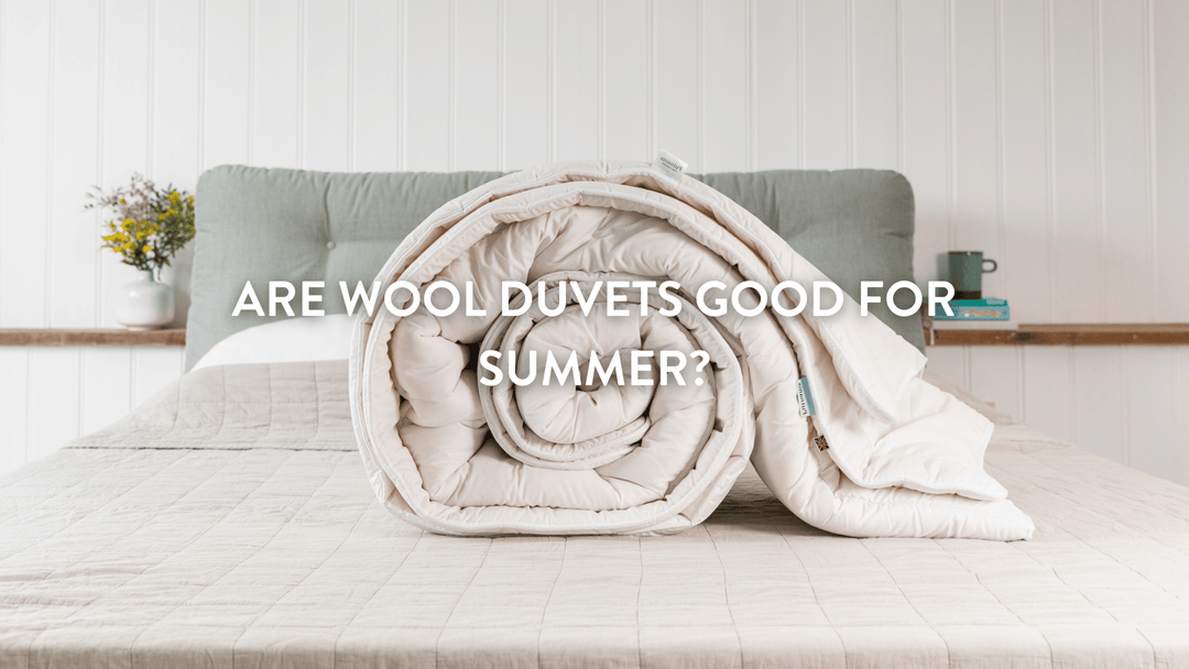 Putnams wool duvet rolled up on bed 