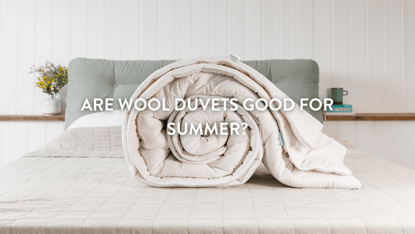 Putnams wool duvet rolled up on bed 