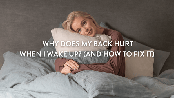 Person sitting on a bed hugging a Putnams pillow to help them from suffering from back pain