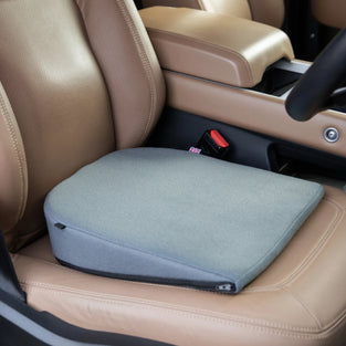 Sitting wedge cushion for car home and office seat. Improves posture in grey, black navy and beige.