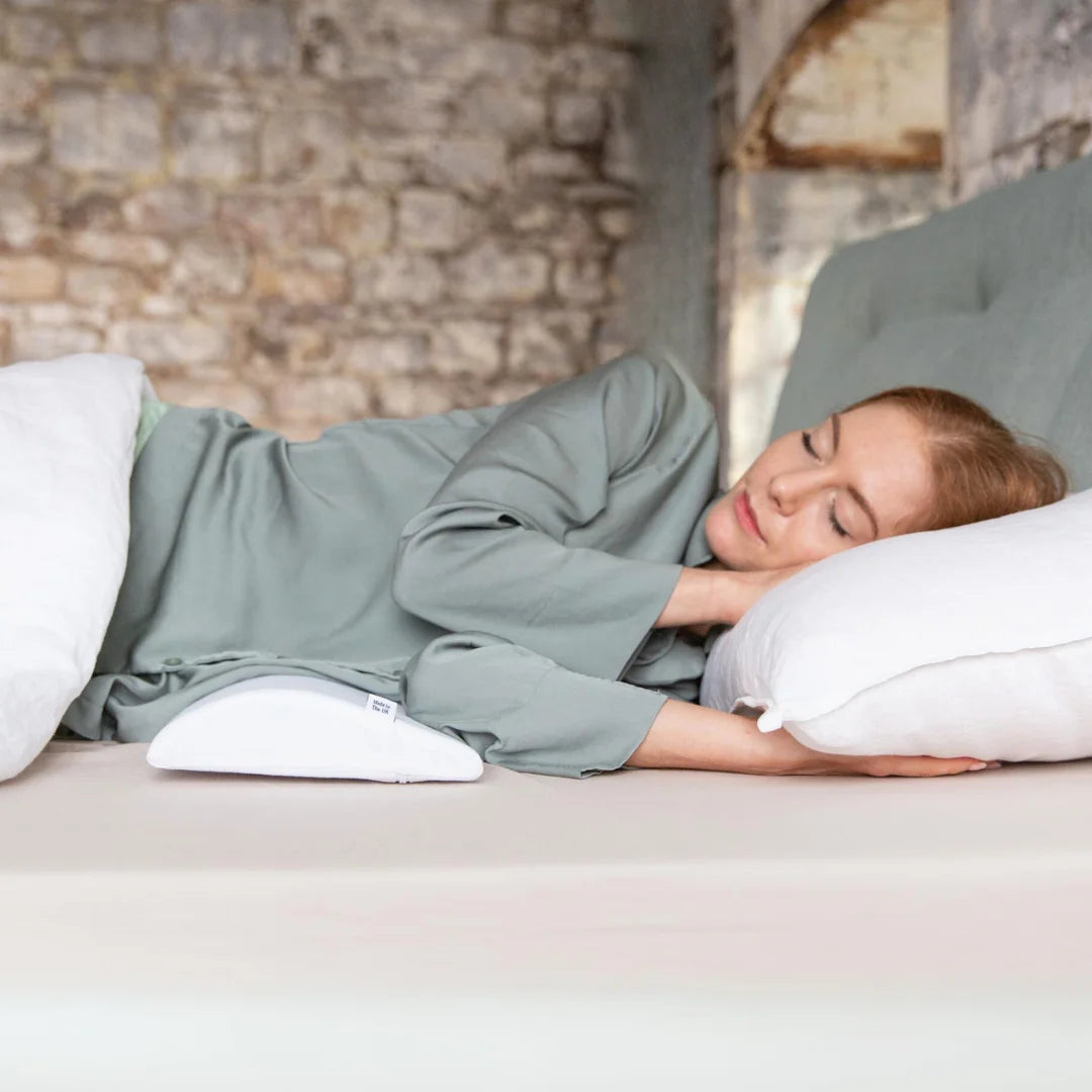 Bed Back Support Pillow - Putnams Place this D shaped firm pillow under the small of your back to support the natural S shape of the spine during sleep. Gives pressure relief to the back when in pain.